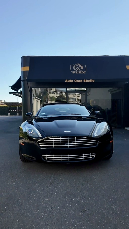 Black Aston Martin DB9 in front of the Flex Auto Care Studio canopy in Pasadena after a signature detail